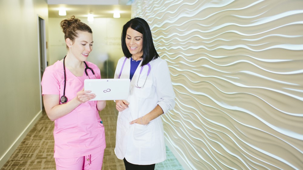 a female nurse and doctor using QC Health on a Microsoft Surface